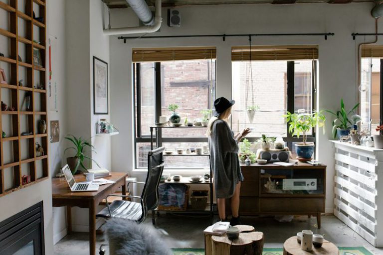 Small Apartment Organization - woman standing near brown wooden cabinet