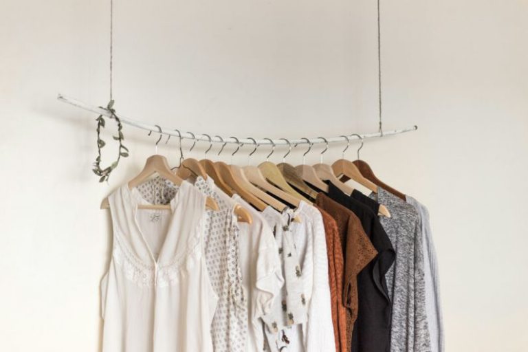 Linen Closet Organization - assorted clothes in wooden hangers