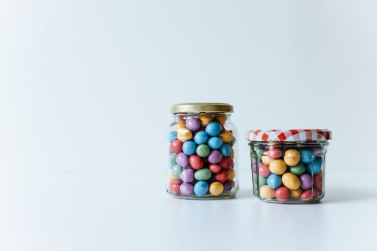 Zero Waste Lifestyle - two glass jars filled with candy beans on a white surface