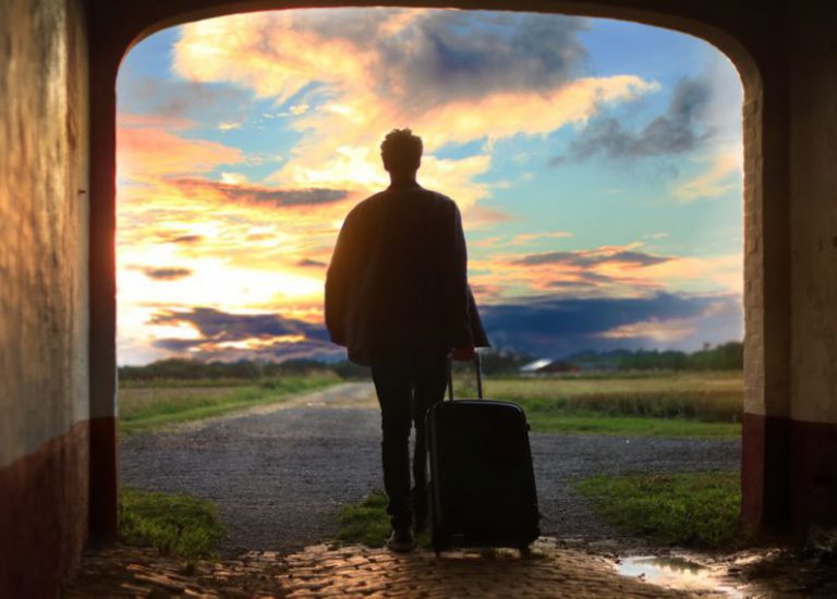 Sustainable Travel - man holding luggage photo