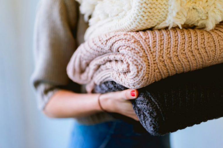 Home Recycling - person holding knitted textiles