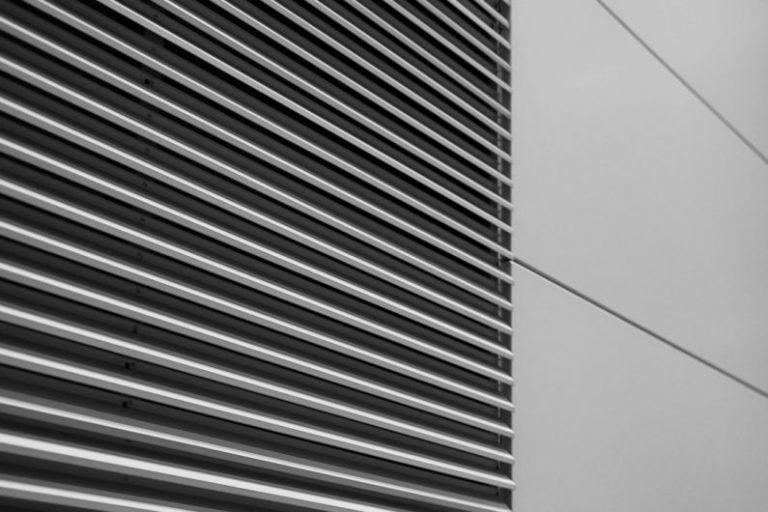 HVAC Maintenance - a black and white photo of the side of a building