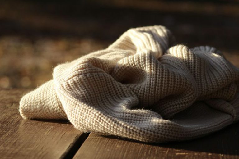 Knitted Blanket - white textile on wooden plank