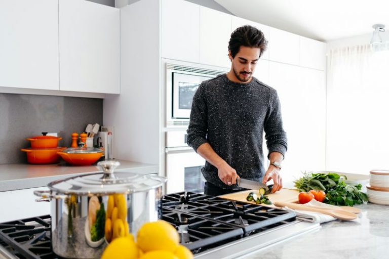 Kitchen Aprons - man cutting vegetables