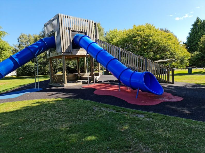 Playground Equipment - a playground with a slide and a play structure