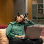 Connectivity Troubleshooting - a woman sitting on a couch using a laptop computer