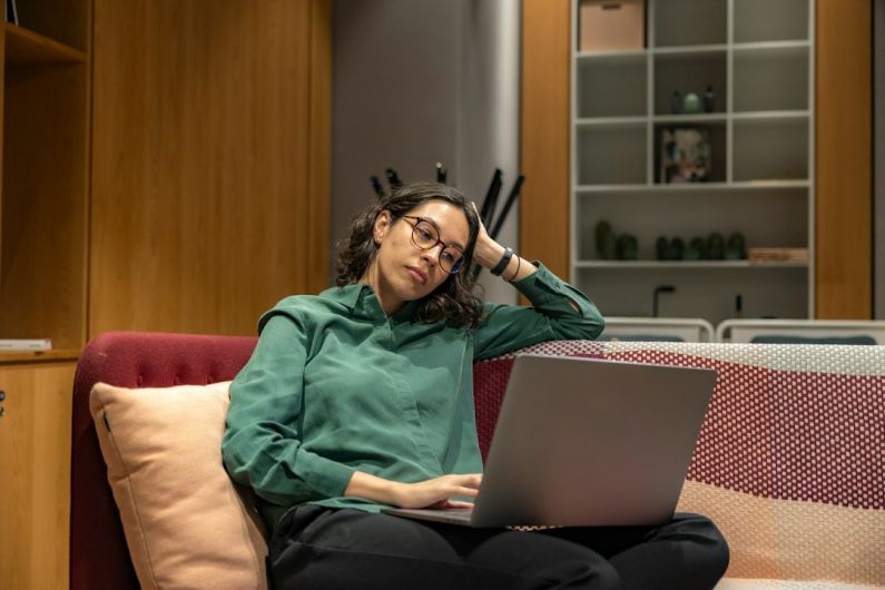 Connectivity Troubleshooting - a woman sitting on a couch using a laptop computer